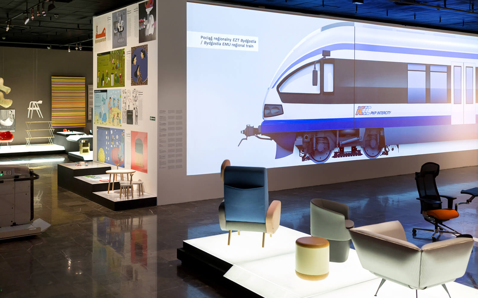 wystawa Z drugiej strony rzeczy. Polski dizajn po 1989 roku, na pierwszym planie krzesła na podświetlanych platformach, w tle projekt tramwaju wyświetlony na ścianie